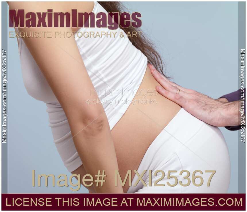 Photo of Pregnant woman with back pain getting massage